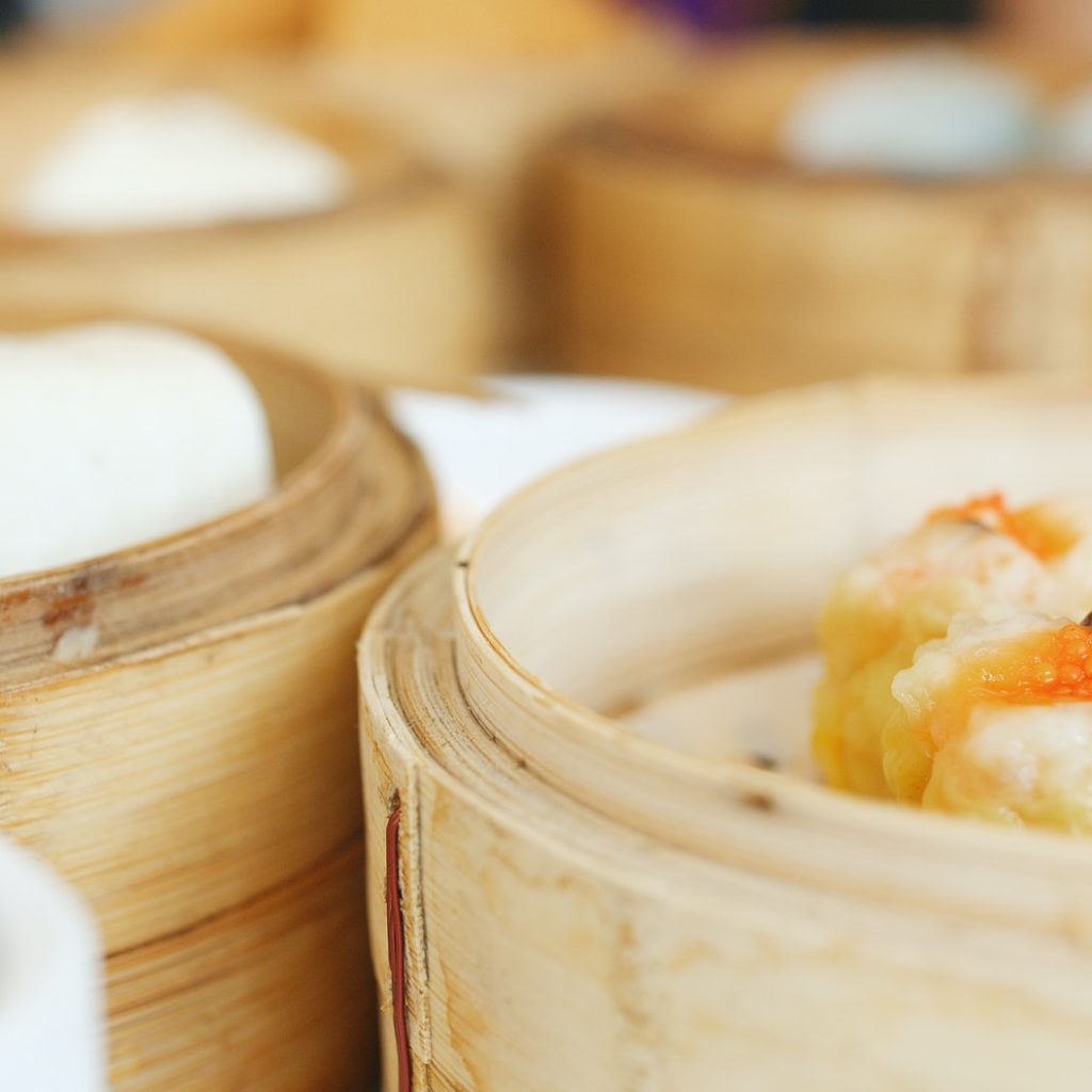 Eating steamed chinese dim sum in restaurant